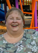 Gwyn Guidy sits on a bench in the park