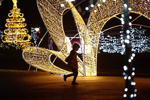 A child illuminated by lights.