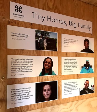 A wall plate shows people working on Tiny Homes, including Sherry.