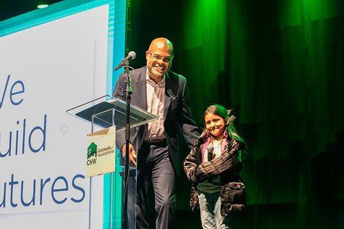 Sean Spear stands with a small child at the organization's annual gala event