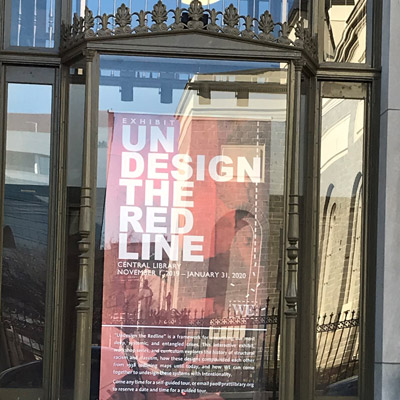 Poster of Undesign the Redline in the window at Baltimore