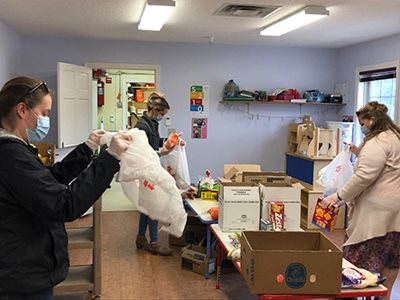 Volunteers assist making care packages for residents, so they can stay safe at home during COVID-19