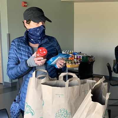 Volunteers and resident coordinators help deliver groceries to residents during COVID-19