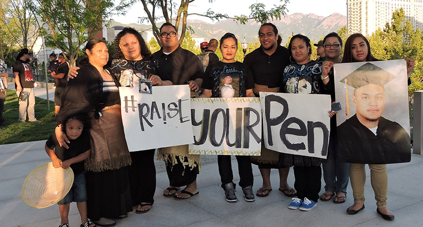 A family celebrates a graduation outside