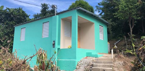 Refurbished and looking good: a bright blue house, painted and ready.