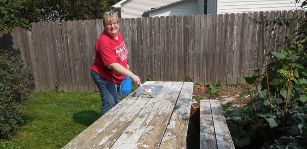 A picnic table needs a little care, but volunteers are prepared to paint.