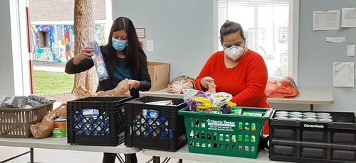 Workers unpack food to help residents.