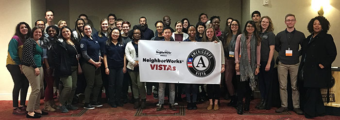 NeighborWorks America VISTA members hold up a VISTA member at the DC training institute