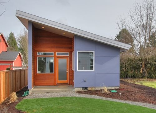 An accessory dwelling, looking very modern with big windows and an angled roof.