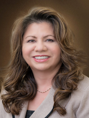 Maria Garciaz smiles, wearing a brown blazer..