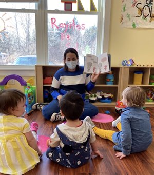 A teacher reads to students at Rayitos De Sol.