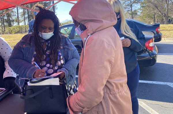 Monica DeLancy hands out checks in Georgia to people in need.