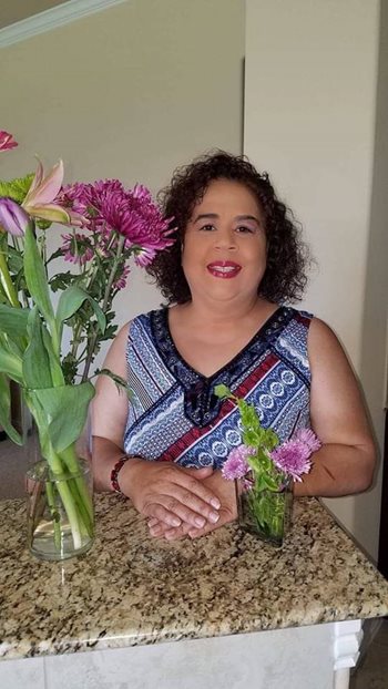 Janice McKinzie, surrounded by flowers.