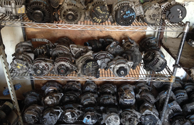 Salvaged alternators sit on a shelf at ODR Auto Wrecking.