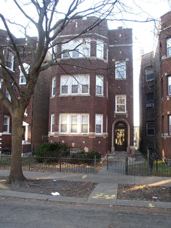 A street in the Chatham neighborhood shows a brick property with a tree out front.