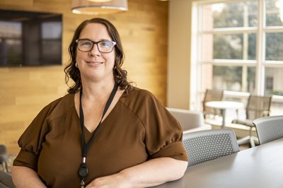 Jodi Smith sits at a table in the Way Finders offices in Massachusetts.