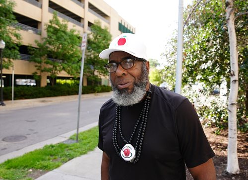 James Page in a hat with an apple on it, representing spiritual apples