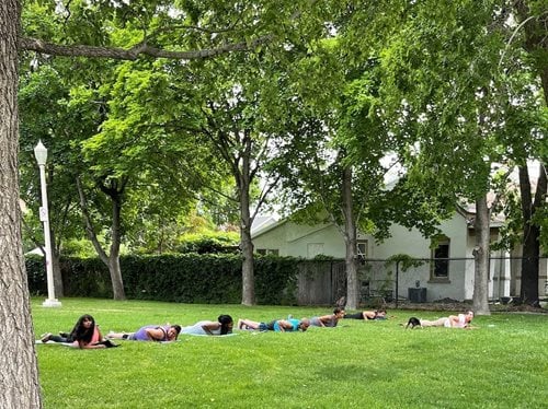 A group of residents participate in Yoga in the Park