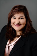 NeighborWorks America's President & CEO Marietta Rodriguez, a woman of color wears a black suit