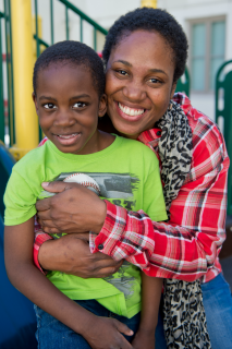 Barbara Thomas and son posing for a picture in the Ping Yuen community.