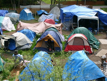 Tents of varying sizes and colors are grouped together