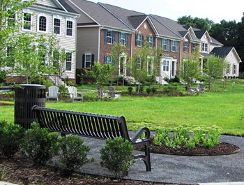 A black bench and a row of multifamily housing