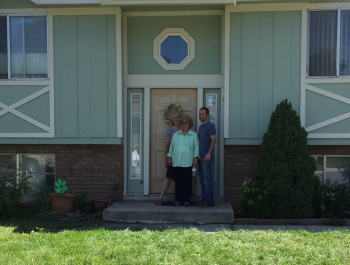 Family standing outside of their home.