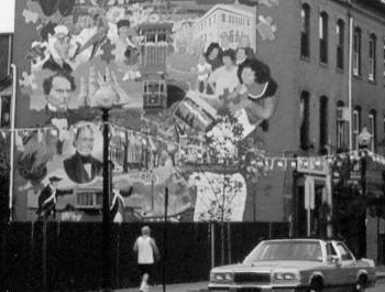 Grayscale photo of a mural depicting various people in a city