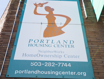 The Portland Housing Center sign on a brick building