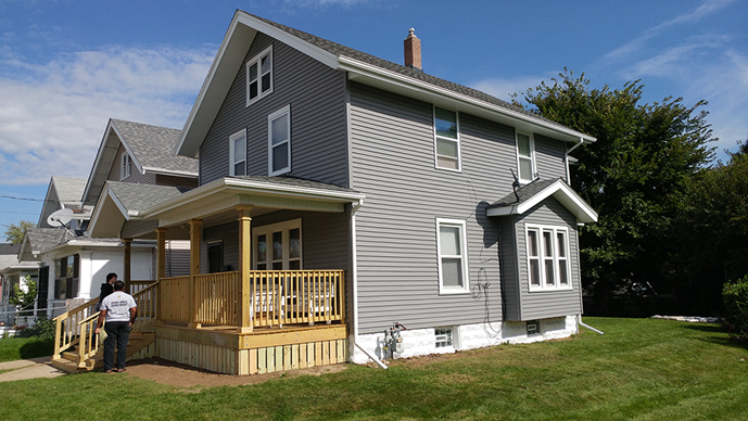 Repaired home with a front porch and blue paint and white trim