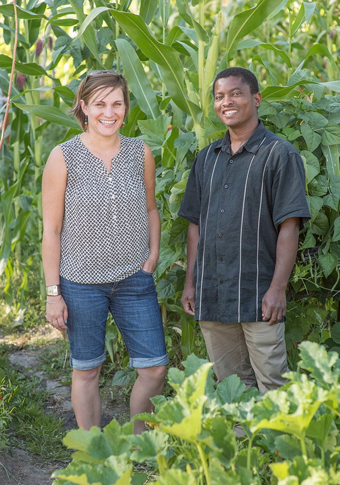 Erin Sorensen stands with a man in the community garden