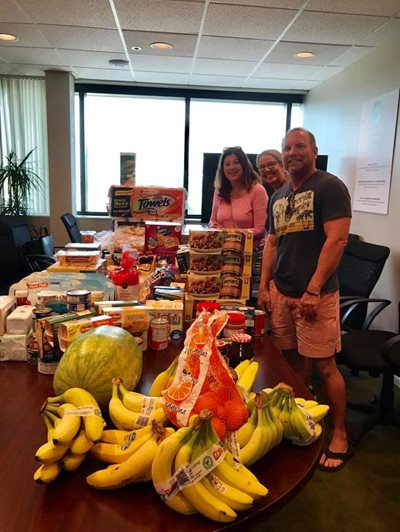 Volunteers at table with food donation supplies